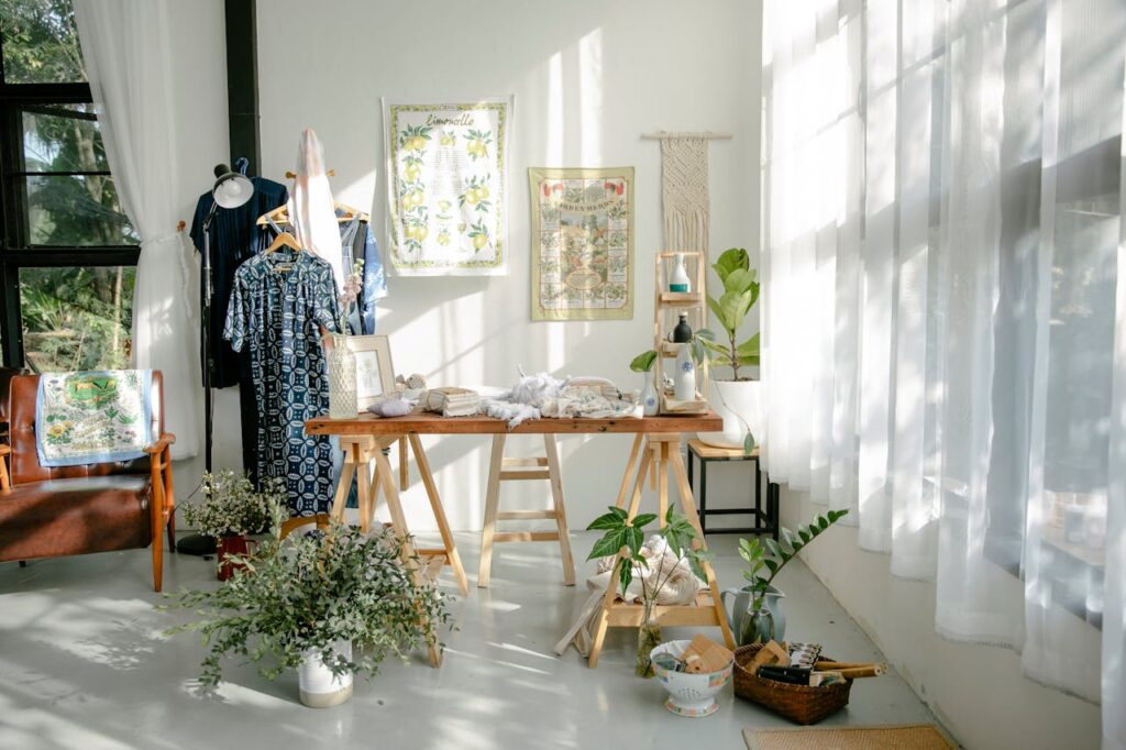 Interior of atelier with table and clothes on hangers